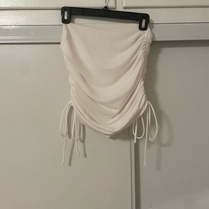 White scrunch skirt with scrunch on sides and a tie.